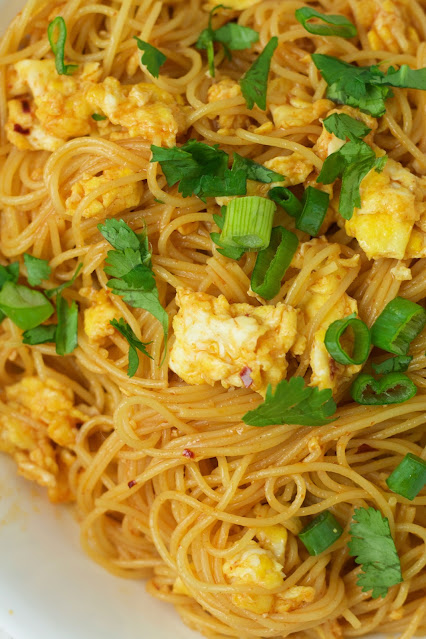 close up of noodles in a white bowl.