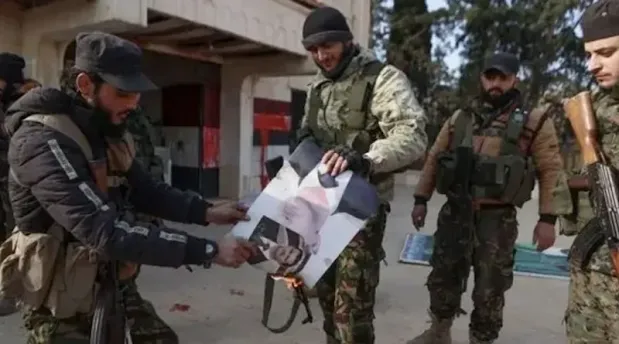Abu Muhammad al-Julani speaking at a press event, highlighting his leadership role in Syria’s ongoing conflict