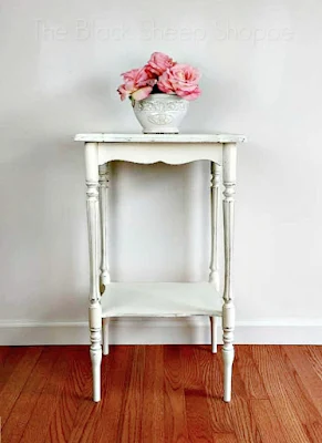 Side table with painted white distressed finish.