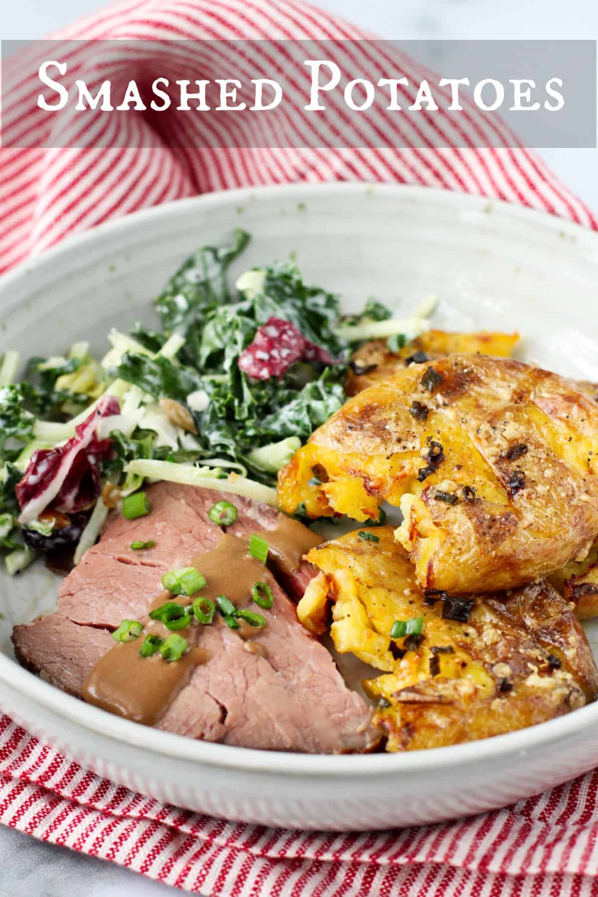 Smashed Potatoes with roast beef and salad in a shallow bowl.