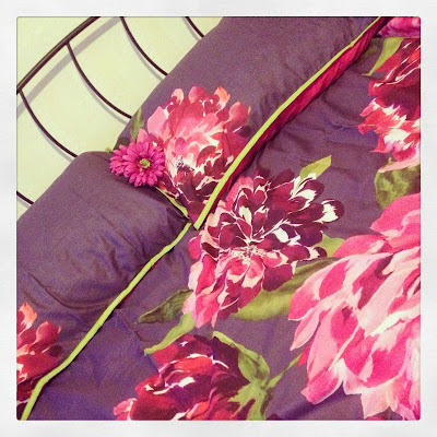 Freshly made bed - new purple floral bedding 