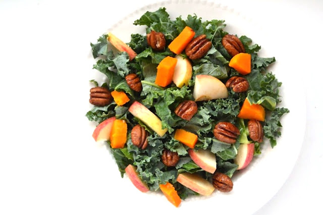 Kale Salad with Spicy Pecans, Apples and Butternut Squash is the perfect fall salad that is topped with an apple cider vinaigrette!  www.nutritionistreviews.com