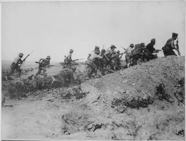 "Soldiers landing on the shores of Gallipoli during the 1915 campaign, navigating rugged terrain under heavy resistance from Ottoman forces."