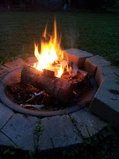 A backyard fire pit with a fire on Lughnasadh 2014