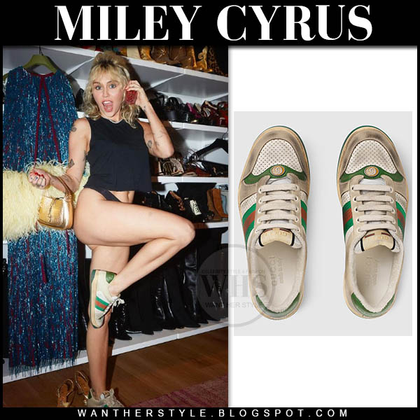 Miley Cyrus in black crop top and Gucci sneakers