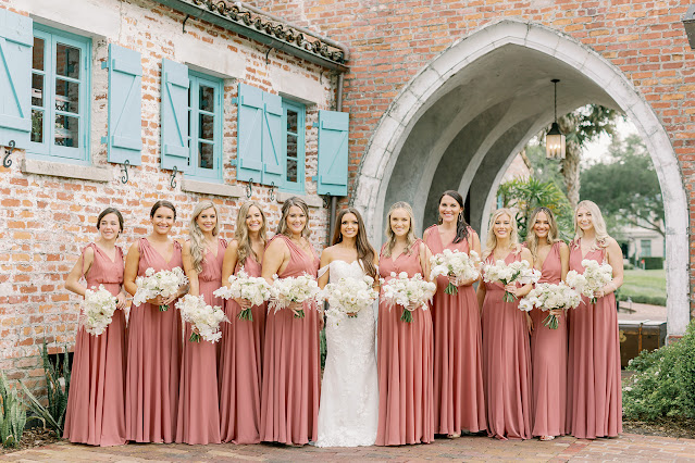 bride with bridesmaids in pink dresses at casa feliz