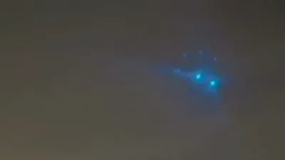 Blue UFO sighting filmed from an aircraft window.