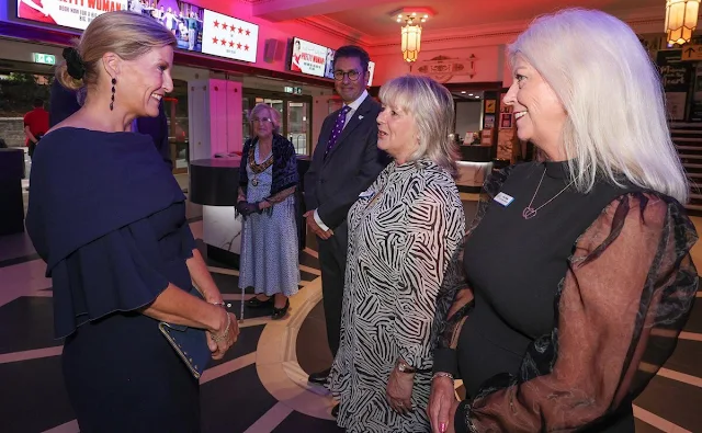 The Duchess of Edinburgh wore a navy Sunyani midi dress by Roksanda. Performer Earl Carpenter