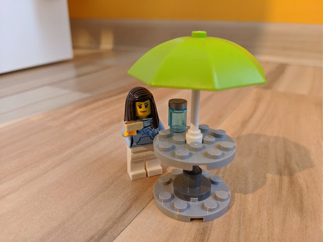 Picture of the patio table being used by the female customer Minifigure