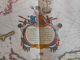 detail of Bermuda map cartouche shown Neptune holding his trident and an ship over a verbal description of the map.