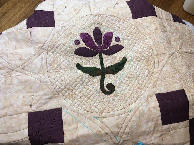 applique quilt with crosshatching done with rulers on a sewing or domestic machine.