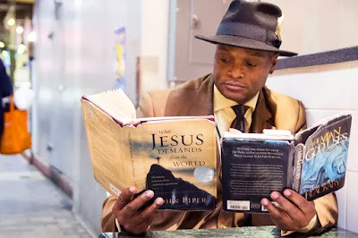 Man reading 2 books