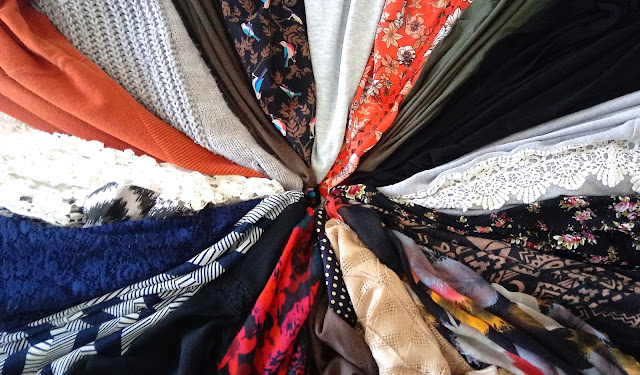 different colors, patterns, and textures of clothing organized in a sort of color wheel