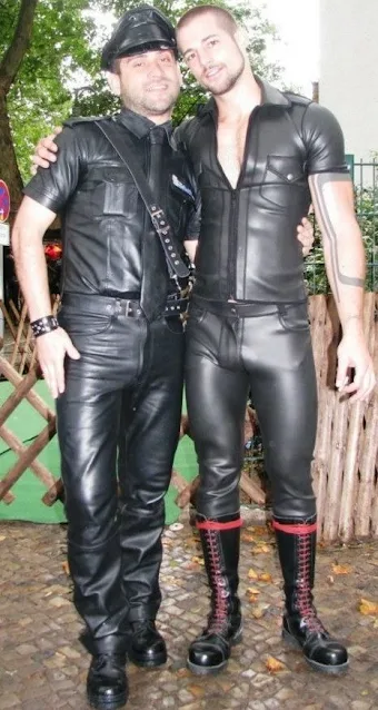 A couple wearing leather clothes smiling poses