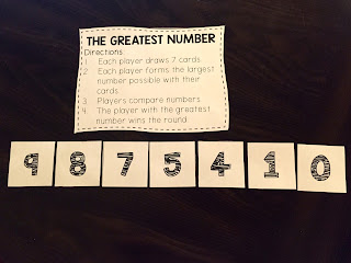 Use number cards to play a place value game