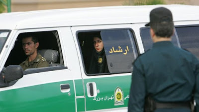 A policewoman looks out of a van of Iran's morality police in Tehran, Iran.