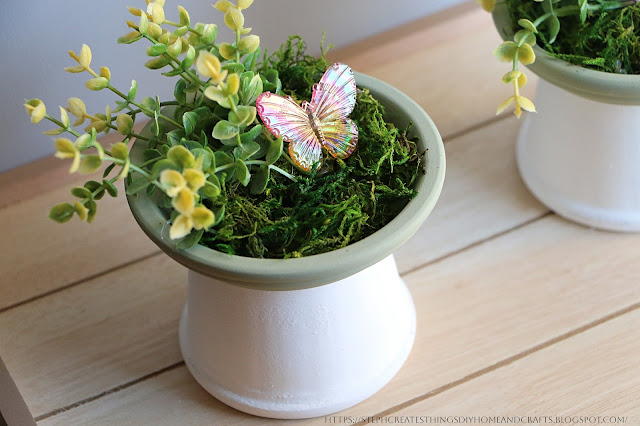 Terra Cotta Painted pot display with faux flowers, moss and butterfly gem