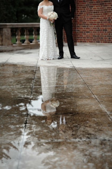 bride and groom with puddle reflection at Grosse Point Academy