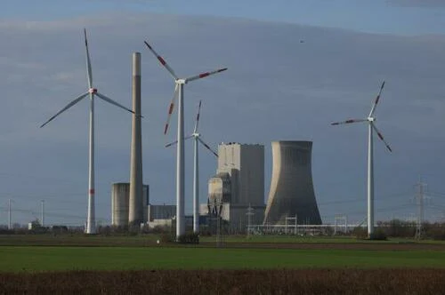 Wind turbines spin near the coal-fired Mehrum Power Station on Feb.14, 2022 in Mehrum, Germany. (Sean Gallup/Getty Images)