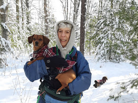 hiker holding dacshund