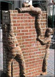 Children Climbing Over a Brick Wall