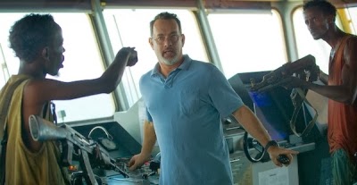 CAPTAIN PHILLIPS starring Tom Hanks (center) and Barkhad Abdi (left)