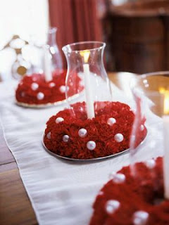 If you are daring brides who want to leave the mainstream of white, cream, ivory and other traditional wedding colors, we present a series of floral arrangements or centerpieces with flowers or red motifs, sure you will choose one for the day your celebration.  In these first two models have long stylized vases inside which carry a red color and detail on top a kind of bouquet of roses the same color.    The difference with the first sample is that it has branches inside the vase.    Elegant centerpiece with branches and red flowers attached to them, to add the necessary brightness will have round lenses.   Elegant, simple and sophisticated, this square glass bowl at the base and red rosebuds on top is definitely a beautiful detail that perfectly complements the other four containers with candles.    Another original centerpiece with flowers at the base, as a skirt, and as many submerged into the vase.    Simple and ideal for informal celebrations are 4 different height vases with red liquid inside and a simple white flowers on long stems inside.     A variation of the above centerpiece, the difference is the size of these, being more short, thin, white flower that covers highlights and its effect is more striking.      Another simple centerpiece with red and green candles around play an important role.    Curious centerpiece placed on some books, is ideal for themed weddings that are related to these texts.    Finally, the perfect combination of flowers, pearls and crystal.    I hope you enjoyed.