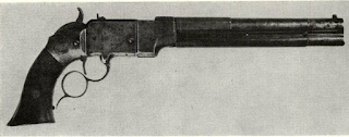 Early lever pistol made by Smith & Wesson in Norwich is distinguished from later “Volcanic” arms by iron frame, and hump behind hammer. Spur to loop is also early S & W motif. Front section of barrel swings to side exposing end of magazine tube for loading, after follower and spring has been pulled up into front section below barrel.