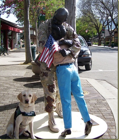 Sculpture titled Coming Home.  Reyna is in a sit say next to the statue.
