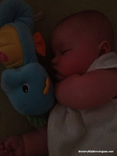 baby snuggled with soothe and glow seahorse 2