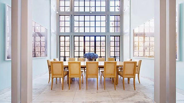 open dining room design with floor to ceiling windows white walls