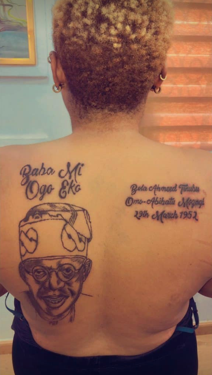 Lady tattoos Bola Tinubu's face, name and date of birth on her back