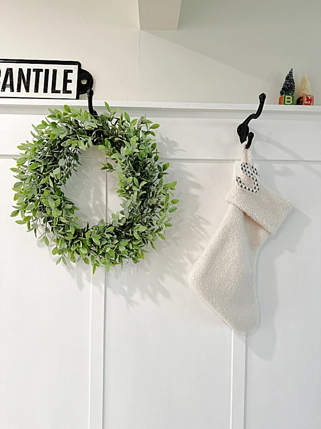 wall with hooks and wreath and stocking