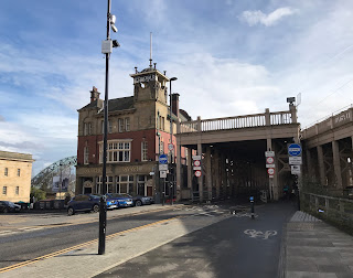 A view down a cycle path and roadway to the opening of the lower storey of the High Level Bridge.  Next to the bridge stands a stone building of maybe Victorian design and this is the Bridge Hotel.  Photograph by Kevin Nosferatu for The Skulferatu Project.