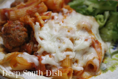 A slightly southernized version of baked ziti, made with the Trinity of southern vegetables, tiny beef and sausage meatballs, a tomato-based sauce with Italian sausage and mozzarella and Parmesan cheeses.