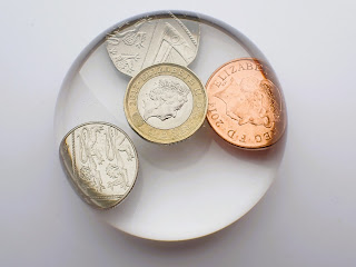 Custom made paperweight containing £1.62 in coins