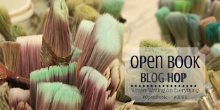 close up image of the tops of paintbrushes with the Open Book Blog Hop logo