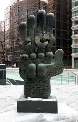 Large bronze sculpture of a stylized hand