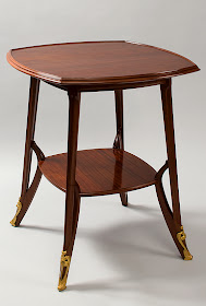 A French Art Nouveau walnut and mahogany table by Louis Majorelle