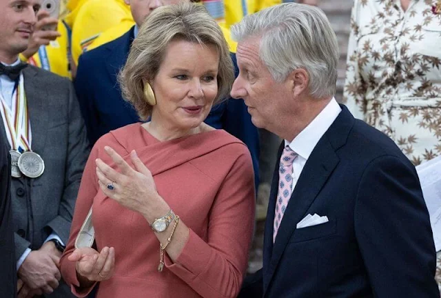 Queen Mathilde wore a new Silvia strawberry wool jersey dress by Natan. Gold earrings. Dries von Noten dress