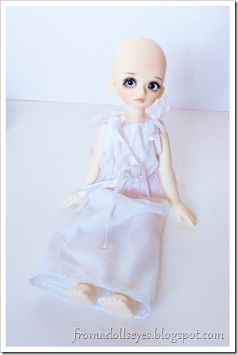 The new Kids Sky yosd ball jointed doll wearing the too big white dress, even though he is a boy.  It looks cute on him anyway.