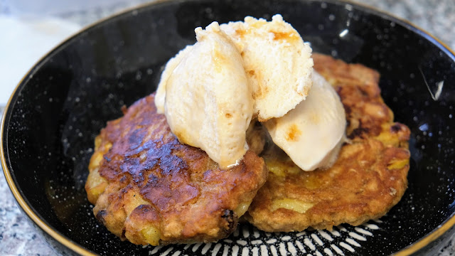 Medieval Apple Fritters with ice-cream in a black bowl