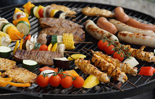 some vegetables and meat on a grill
