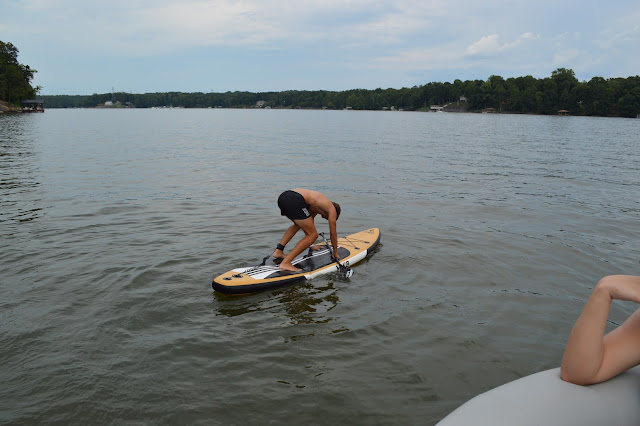 Josh beginning to stand on the paddleboard.