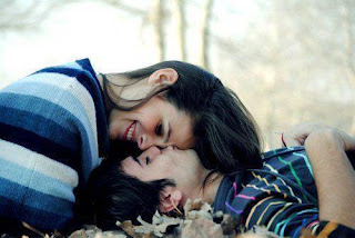 boy kissing on girl's head