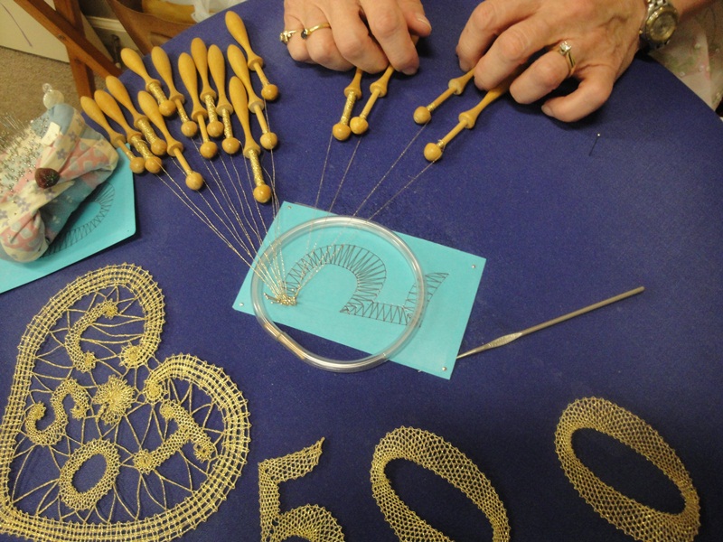 Lisa is working on lace decorations for her golden wedding anniversary in a