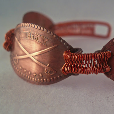 copper bracelet made with a pressed penny with image of crossed civil war swords