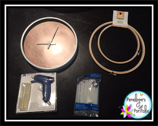 Supplies such as glue gun, glue sticks, craft hoops, and clock needed to make a crayon clock