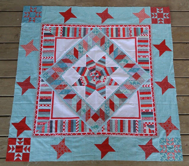 Red and aqua string star round robin quilt