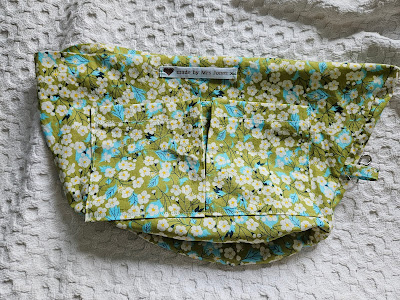 Green floral bag lining before insertion into the basket.